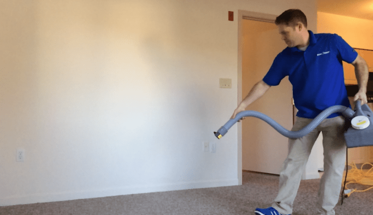 a person is spraying deodorant in a room