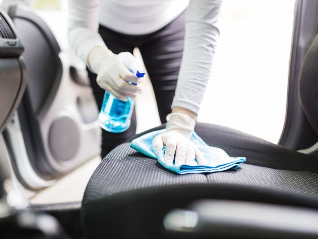 cleaning car seats with cloth.